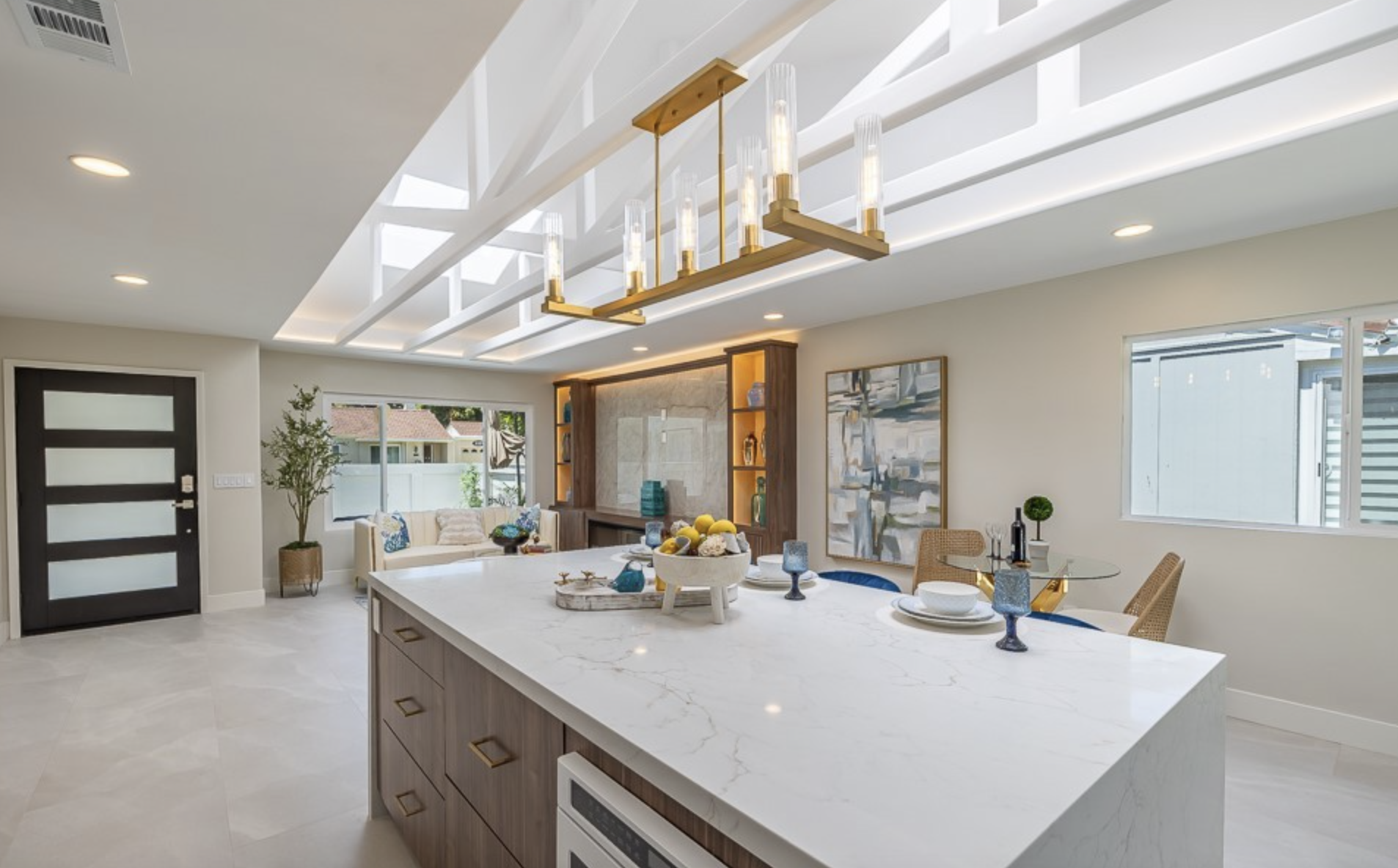 Kitchen island with waterfall counters and vaulted beam ceiling