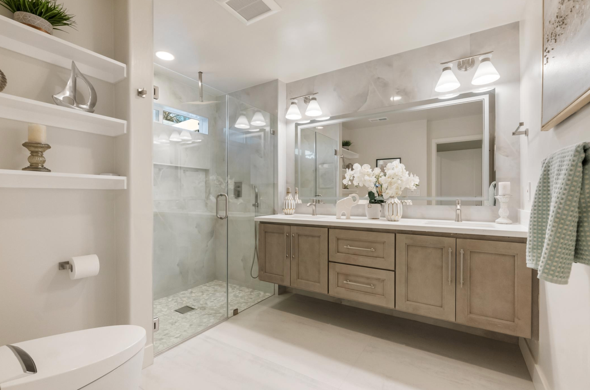 Spa-style primary bathroom with walk-in shower and double vanity